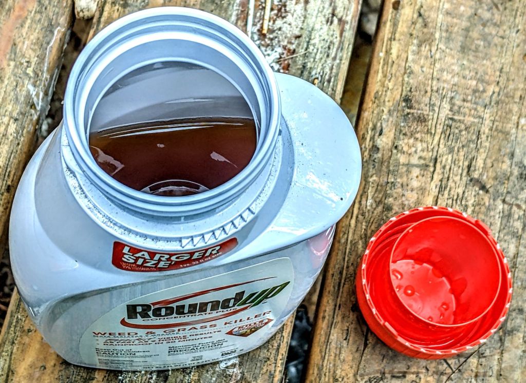 Roundup bottle, looking down into opening, showing spill hazard
